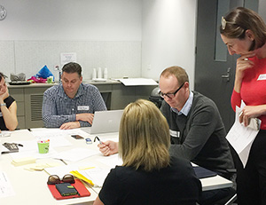 photo showing person organising recruiting with a list, guide, and their laptop computer